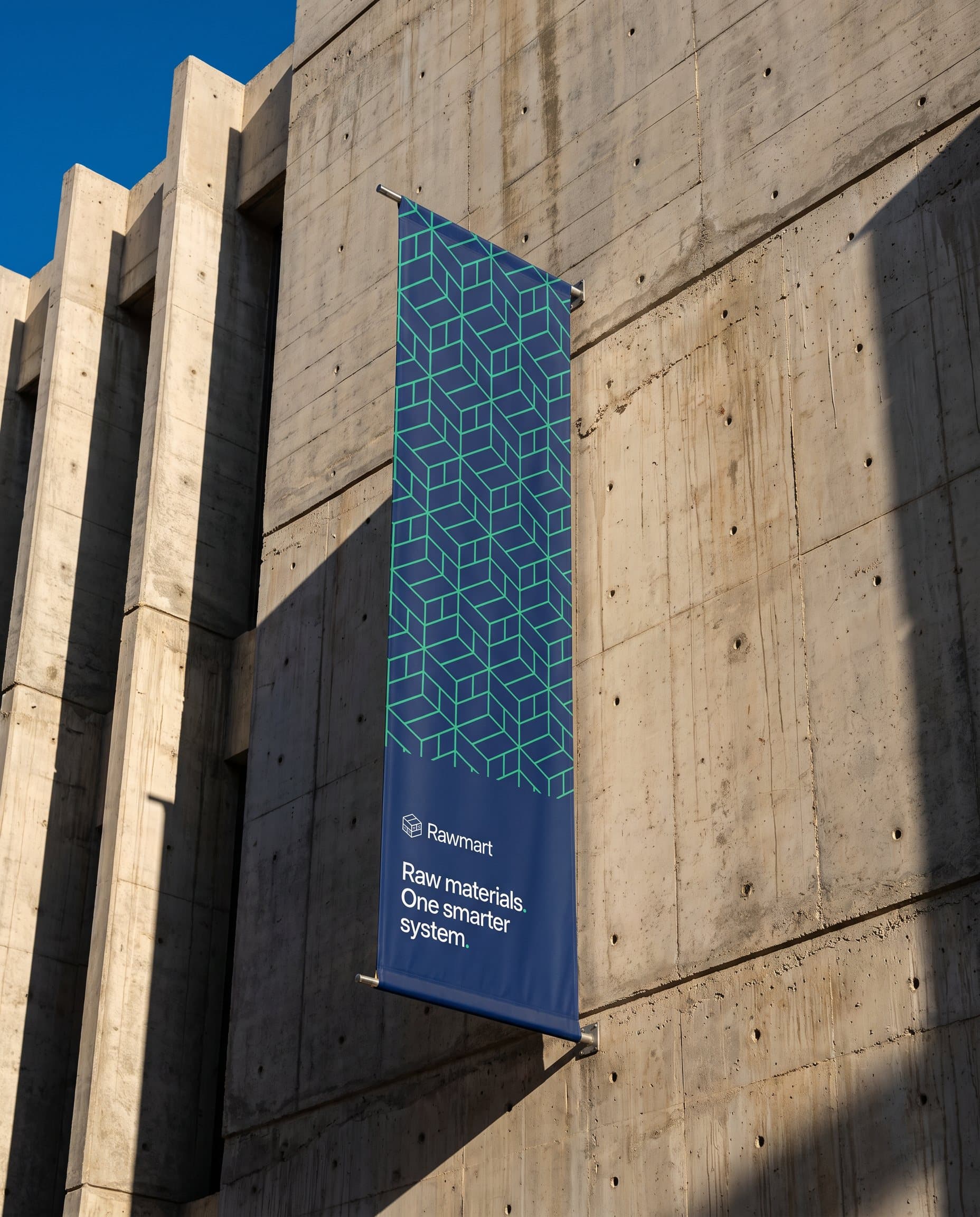 A navy Rawmart banner hanging on a concrete facade