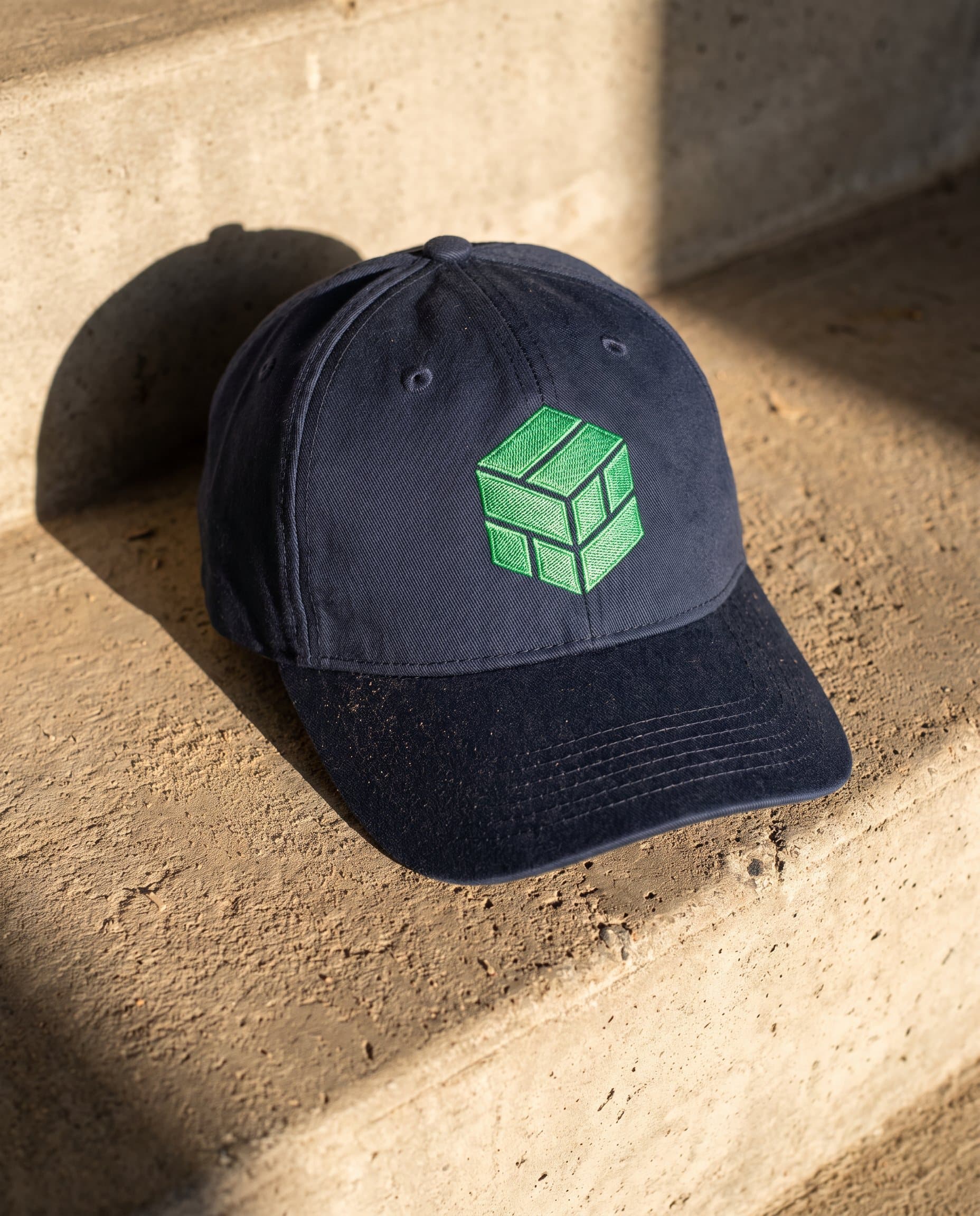 A navy cap with the green Rawmart module