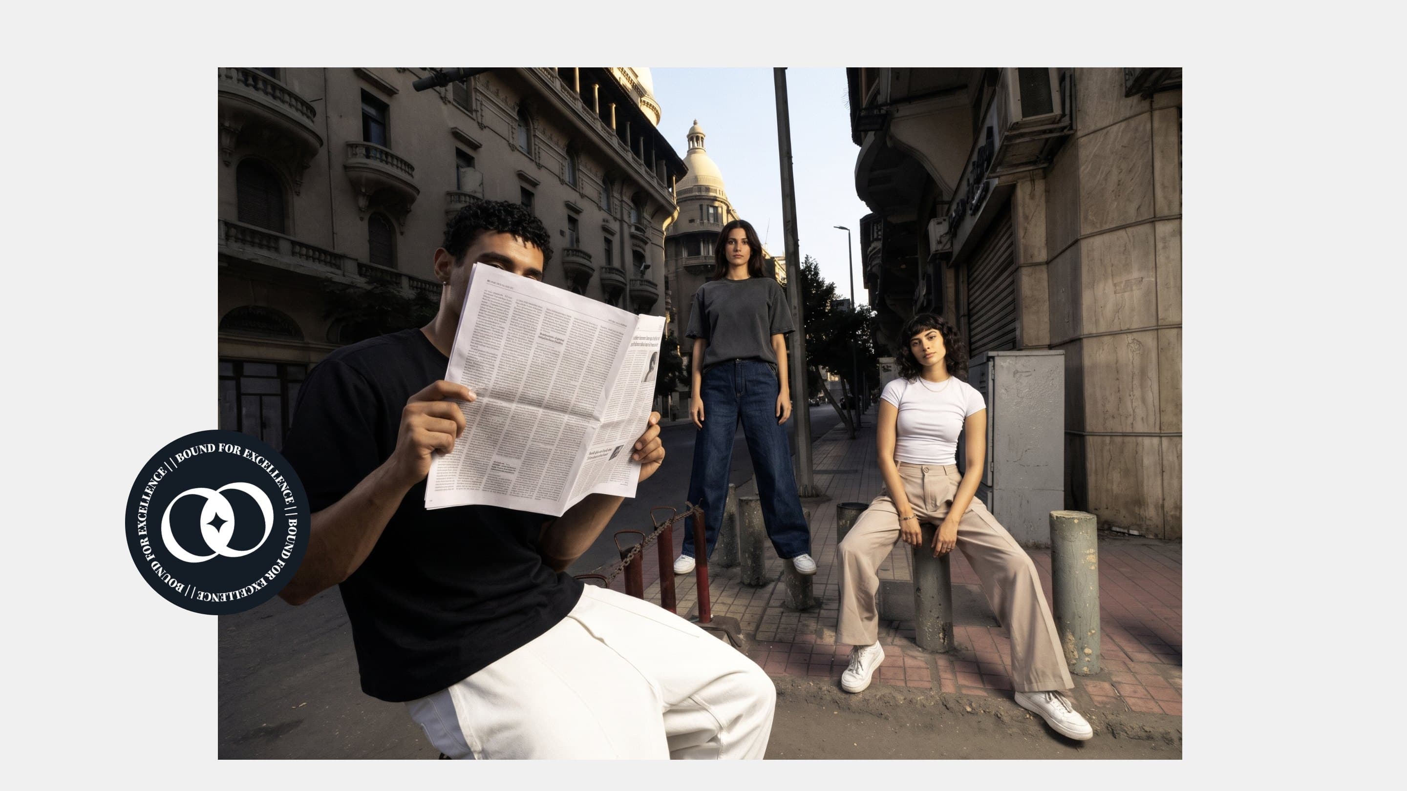 Three models on a downtown Cairo pavement, with the Bound for excellence badge
