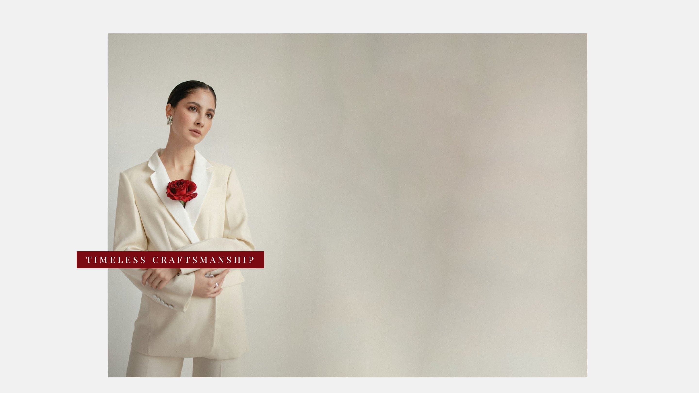 A woman in an ivory suit with a red rose, a Timeless craftsmanship tab laid across