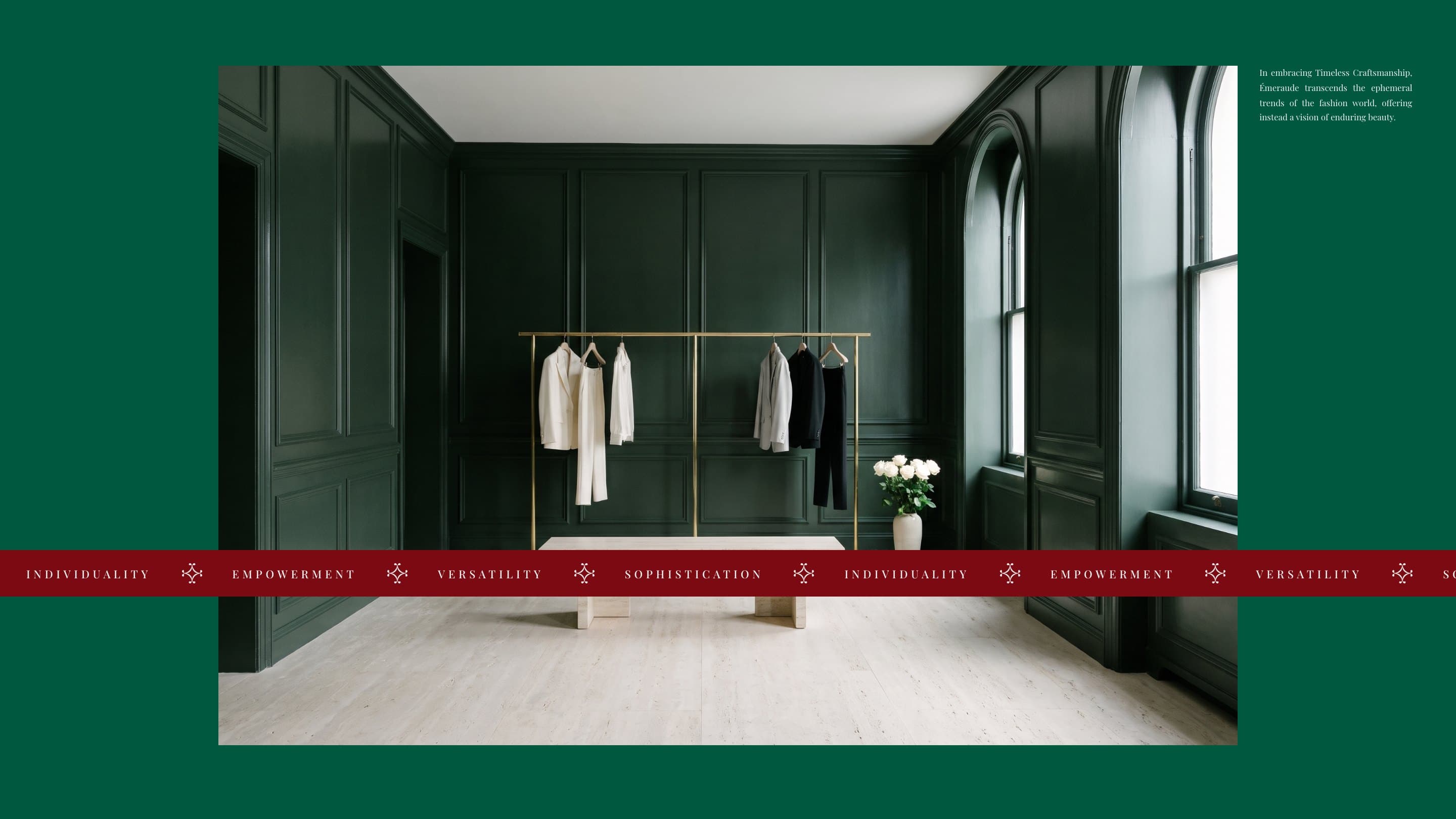The Émeraude boutique in deep green panelling and travertine, a brass rail of ivory and black tailoring and white roses, the band of Individuality, Empowerment, Versatility and Sophistication across it