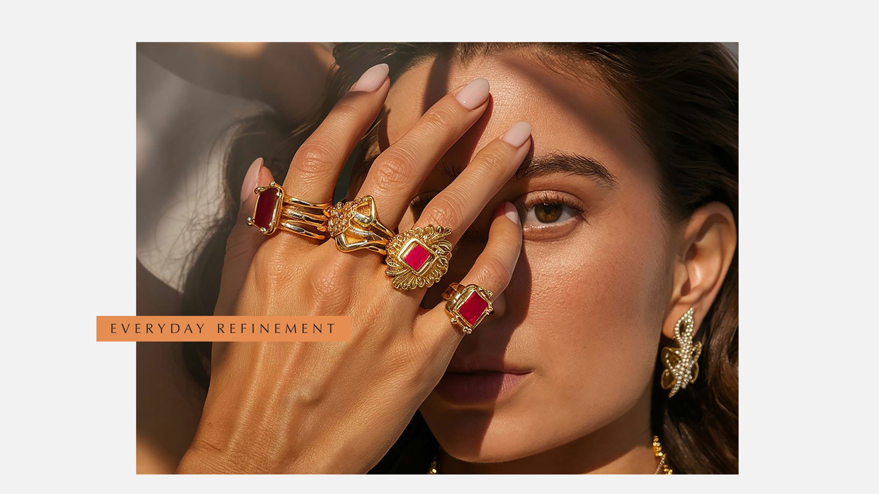 Gold rings worn across the eye, an Everyday refinement tab laid across the photograph