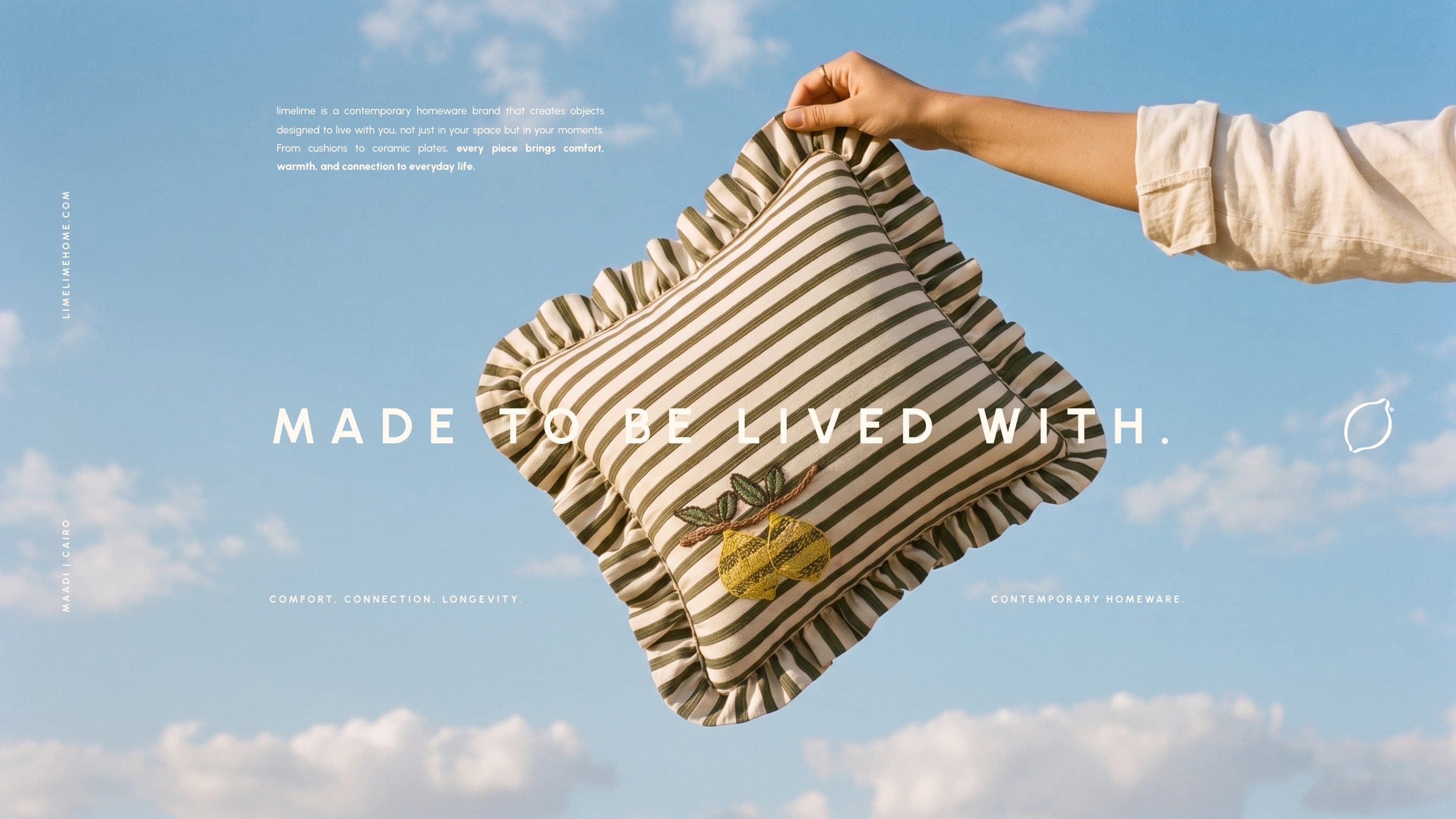 A hand holds the Ruffle Stripe Cushion up against a Cairo sky: made to be lived with