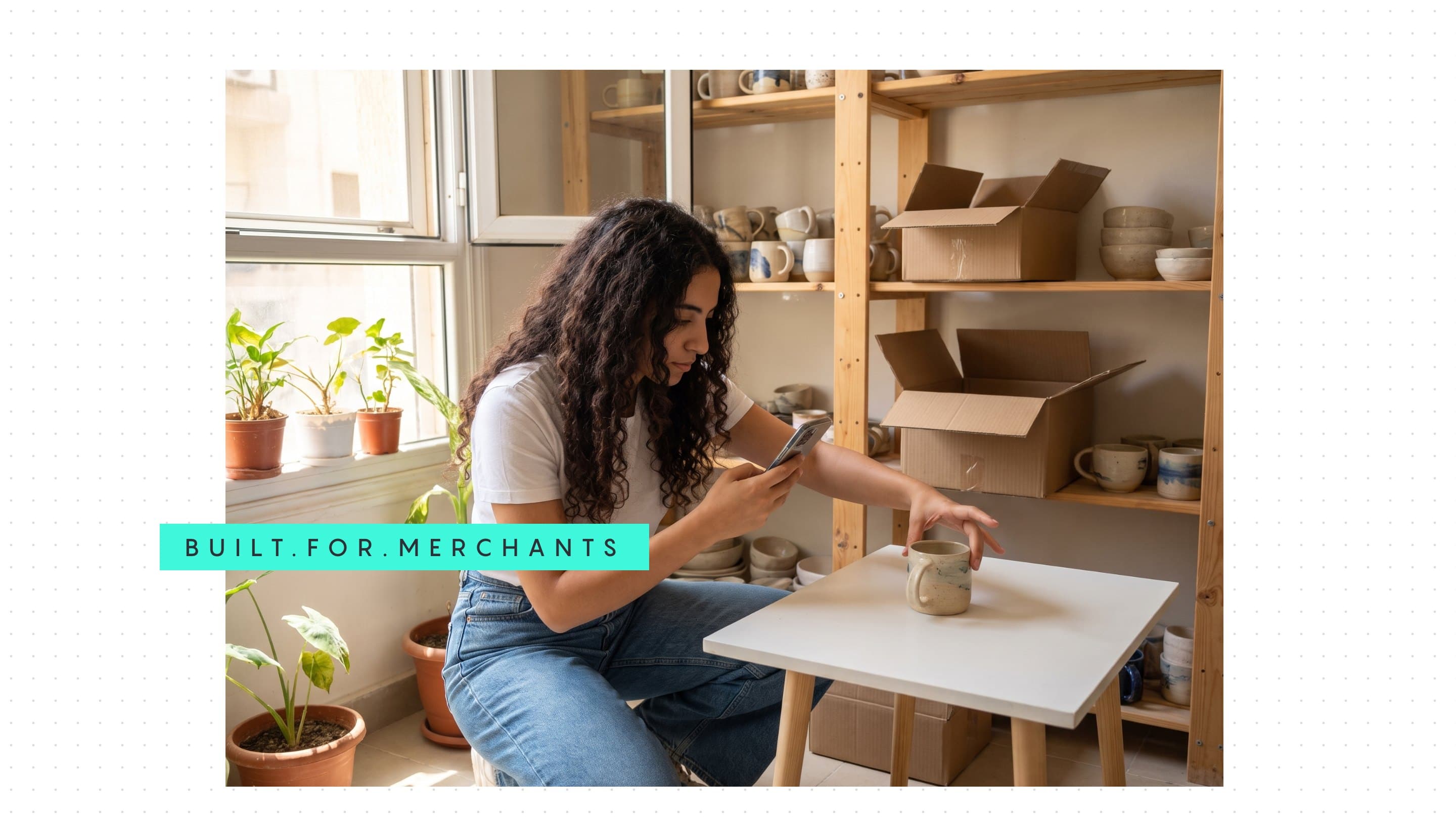 A merchant photographs a mug for her shop in a sunlit home studio, under a green Built for merchants tab