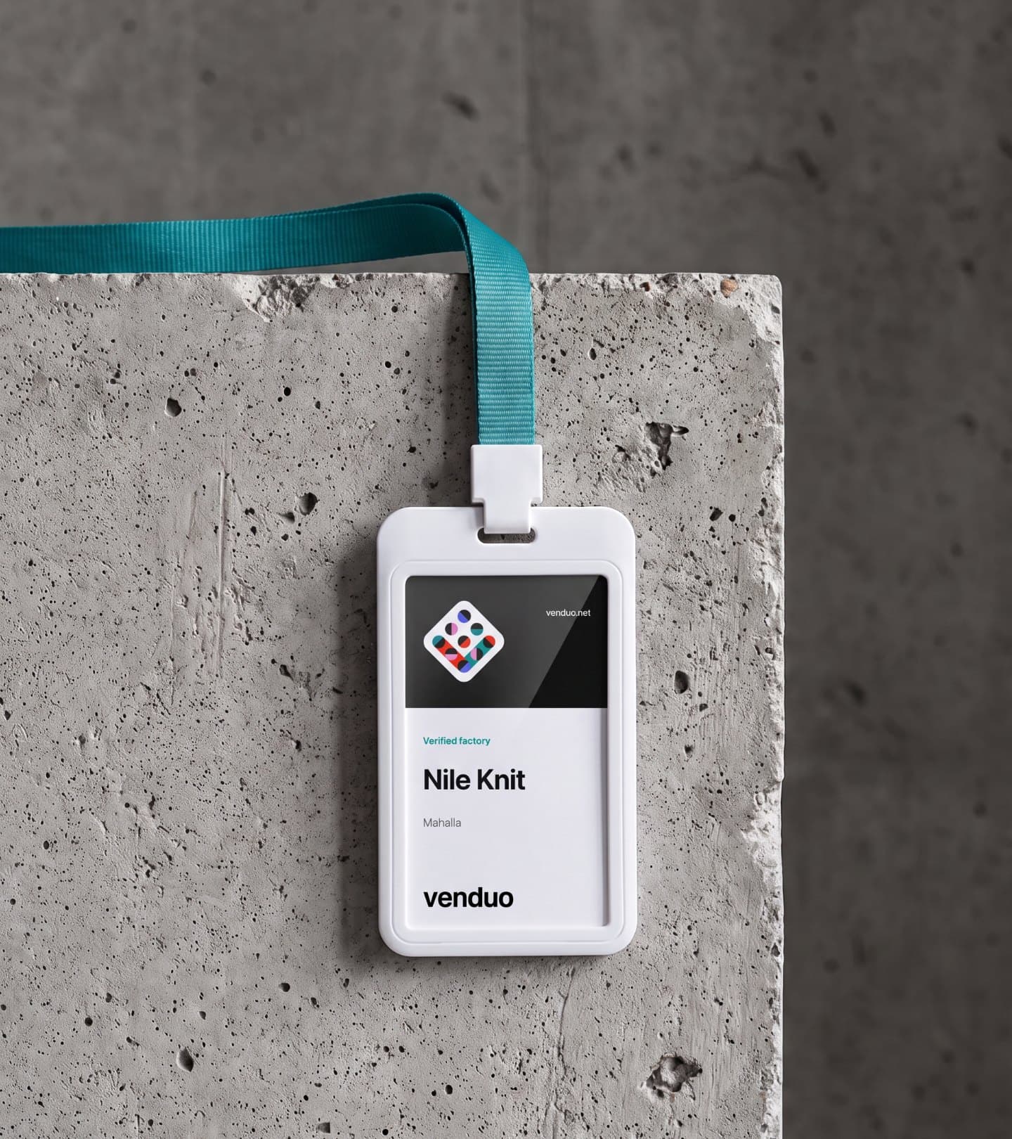 A verified factory's badge on a teal lanyard