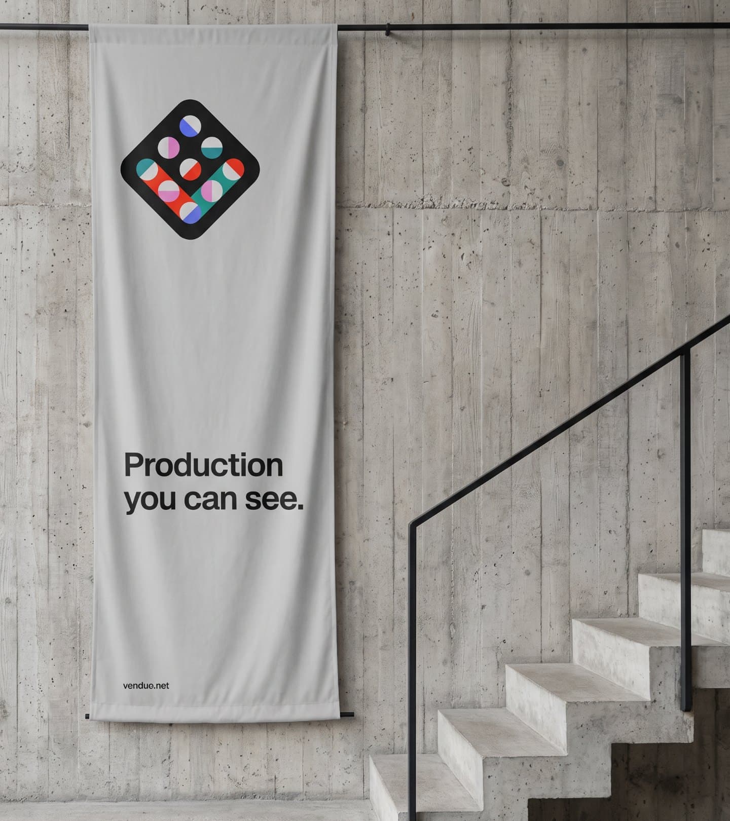 A grey fabric banner by concrete stairs: Production you can see.