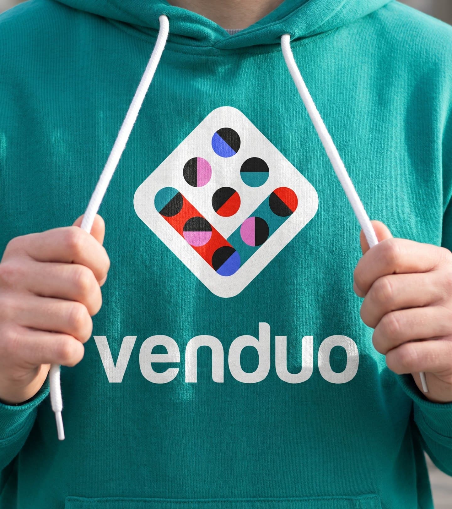 A teal hoodie printed with the mark and the venduo wordmark